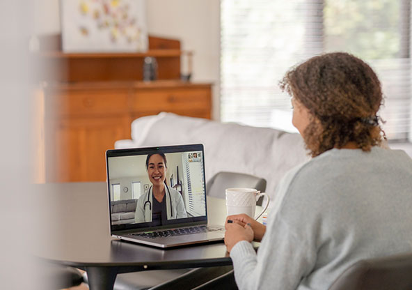 A woman visiting with her doctor through On Demand Care